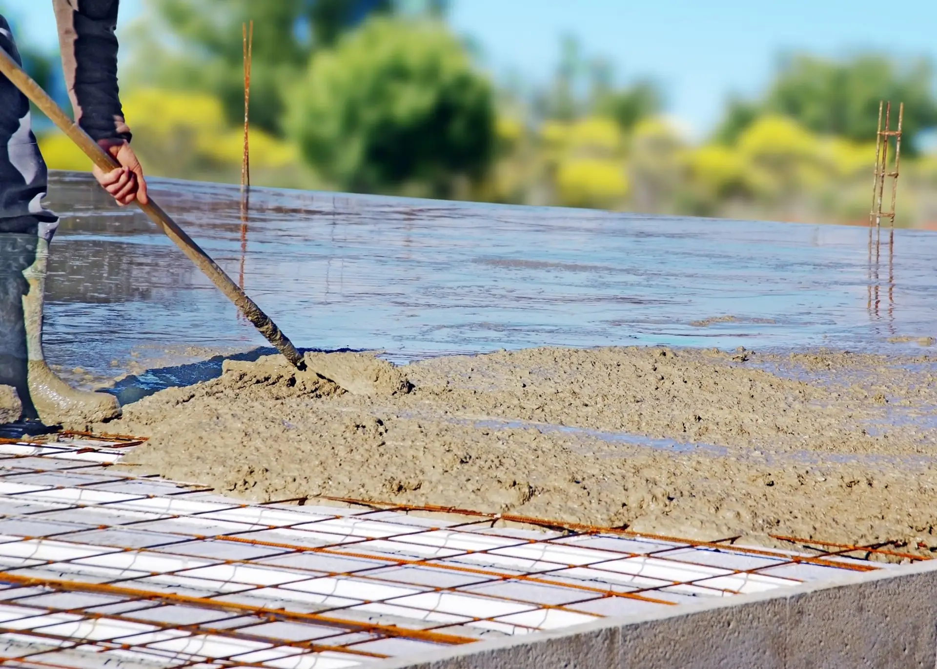 Workers placing concrete for foundation construction